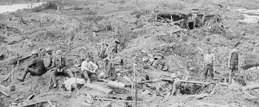 Smashed German trenches and dug-outs near Boezinge, 5th August 1917. A Brritish working party resting in foreground. © IWM Q 3090