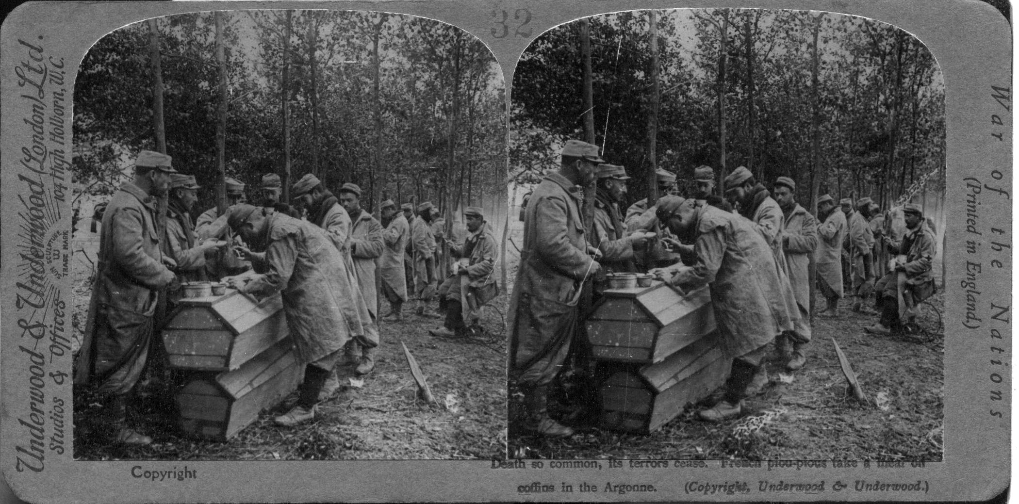 Death so common, its terrors cease. French poilus take a meal on coffins in the Argonne