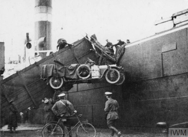 A Group Of British Troops Land A Staff Car From A Boat Onto A Dock