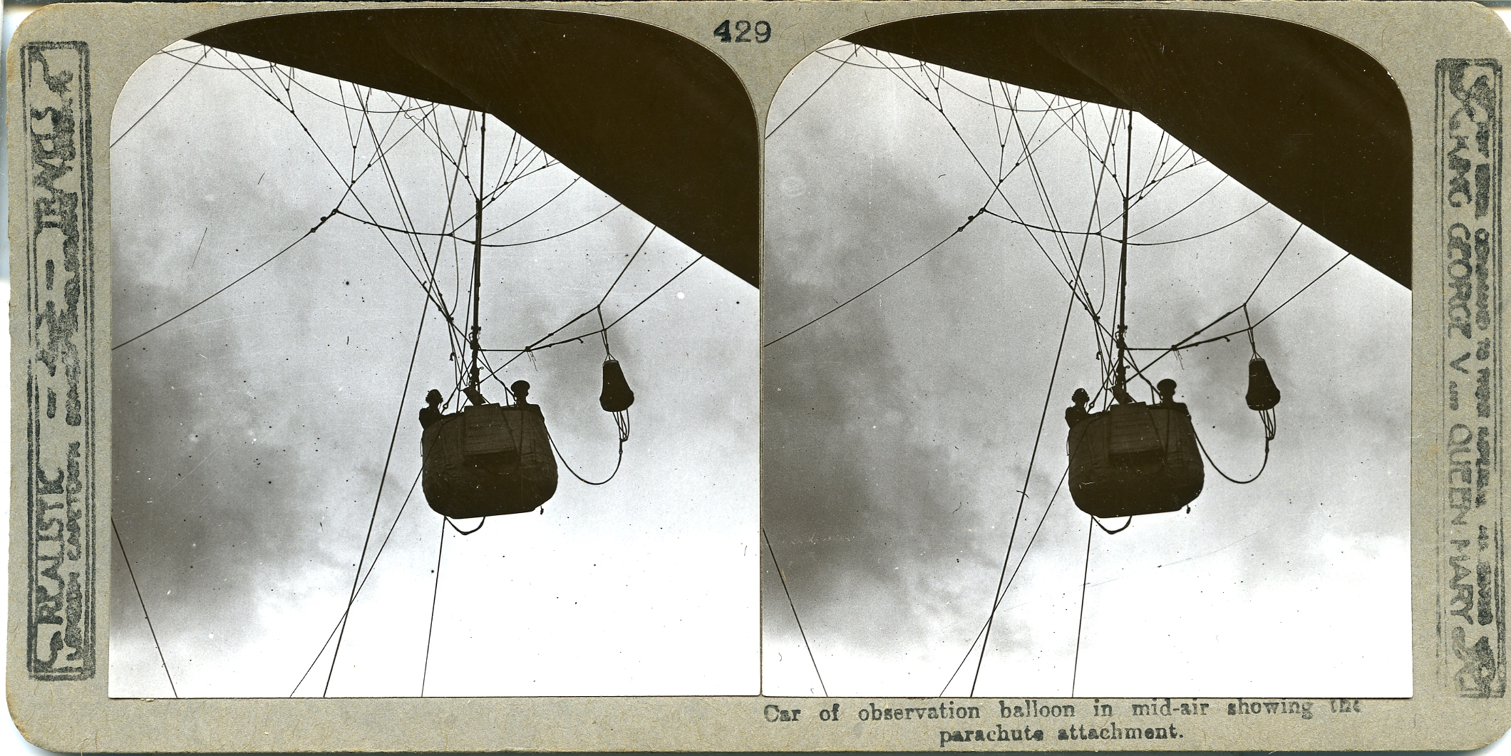 Car of observation balloon in mid-air showing the parachute attachment