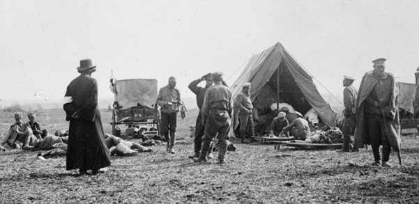 "Batyushka, a Russian priest coming to offer his aid and prayers to the wounded at a roadside First Aid Post. © IWM Q 97842