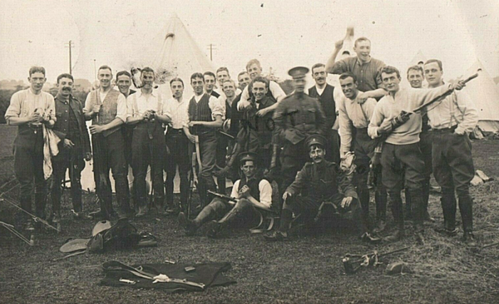 Group of the 1/1st Hampshire Carabiniers Yeomanry cleaning rifles from a postcard taken in September 1914