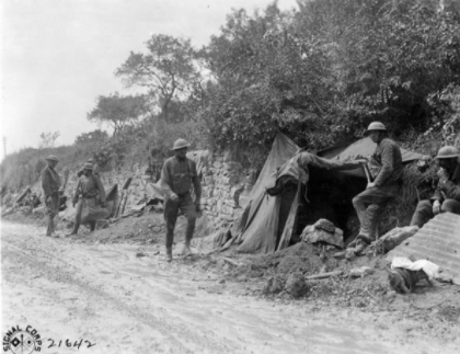 Soldiers of the 107th Infantry Regiment of the 27th Division waiting to head for the front lines and replace British troops near St. Gillis France on 12 August 1918 in this U.S. Army Signal Corps photo.