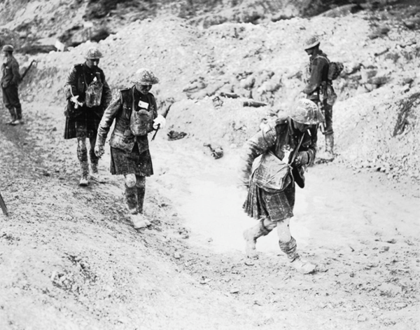 Hill 70 (Lens) 15-25 August: Three walking wounded from a Canadian Scottish Regiment coming in from the attack on Hill 70. (IWM CO1753)