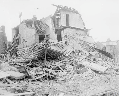 A half-destroyed building in Streatham, London after the Zeppelin raid of 23 to 24 September 1916. Home Office photographer, September 1916, London.  IWM (HO 101)