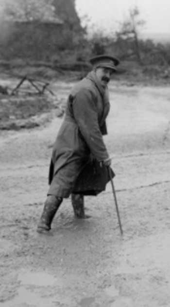 The war artist Lieutenant Muirhead Bone crossing a muddy road, Maricourt, September 1916.