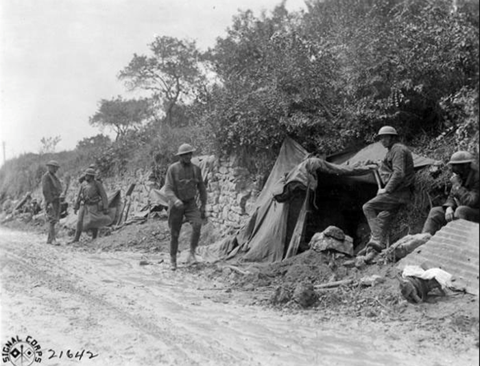 Soldiers of the 107th Infantry Regiment of the 27th Division waiting to head for the front lines and replace British troops near St. Gillis France on August 12, 1918 in this U.S. Army Signal Corps photo. (Photo Credit: U.S. Army)