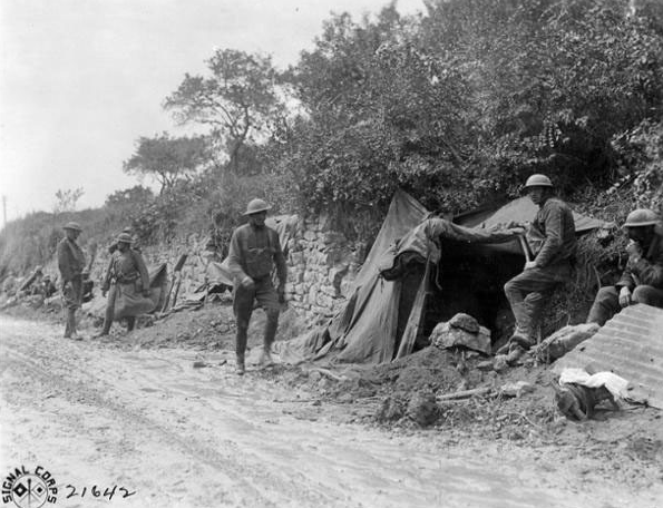 Soldiers of the 107th Infantry Regiment of the 27th Division waiting to head for the front lines and replace British troops near St. Gillis France on 12 August 1918 in this U.S. Army Signal Corps photo. (Photo Credit: U.S. Army)