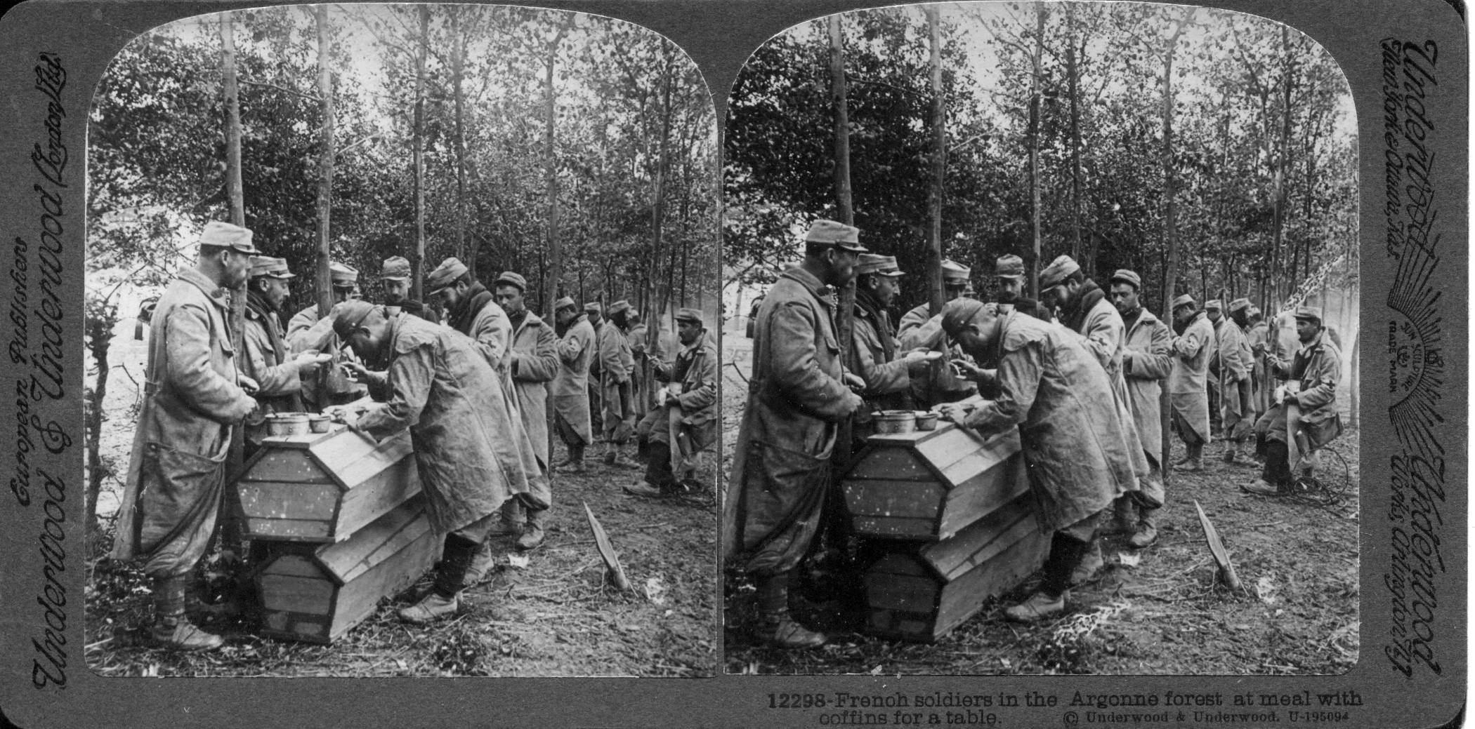 French soldiers in the Argonne forest at meal with coffins for a table