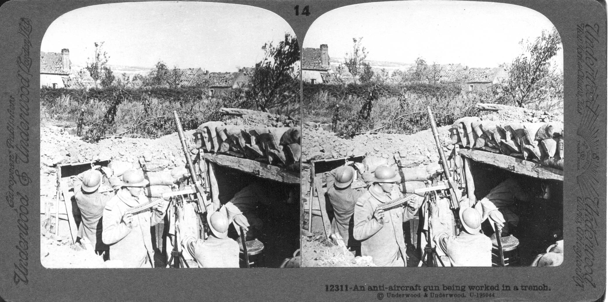 An anti-aircraft gun being worked in a trench