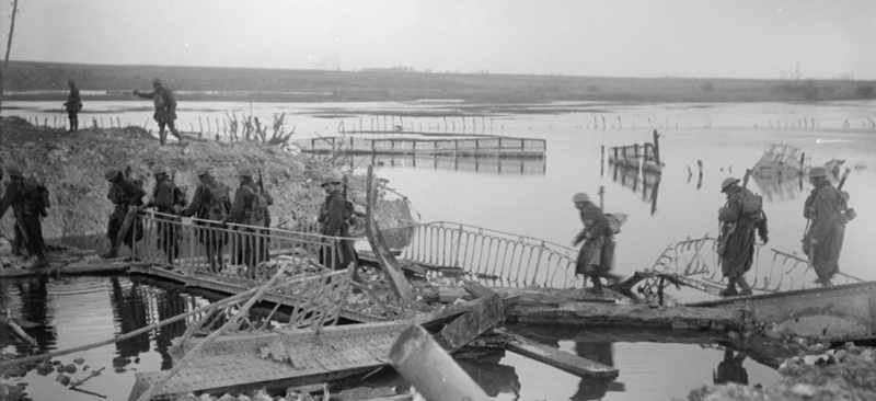 British troops are seen crossing the River Somme at Brie, near Peronne, 20th March 1917, following the German withdrawal.  © IWM Q 1828