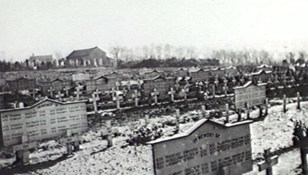 Memorial boards amongst the rows of graves at Boulogne Eastern Cemetery.