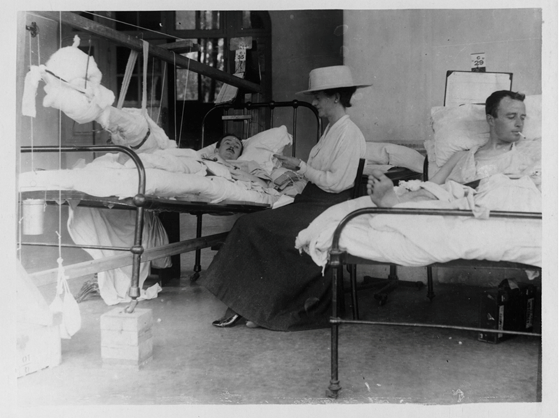 ‘A mother reading to her son some kind messages from various friends’. Photographed by Ernest Brookes. National Library of Scotland License: CC BY 4.0