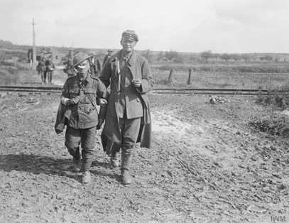 Battle Of Epehy. Wounded And Prisoners Coming In, Near Epehy, 18Th September 1918. The Wounded Soldier In The Foreground Is From A Bantam Unit. © IWM (Q 11329)