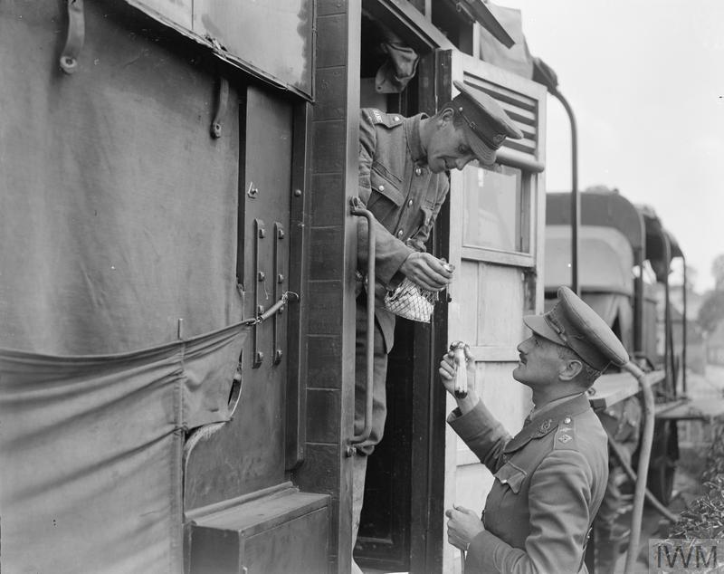 RAMC Chemist Of No. 2 Water Tank Company ASC (Attached To The 718Th Motor Transport Company, Army Service Corps) And One Of His Sergeants Carrying Out An Examination Of Water. Auxi, 7 June 1918.