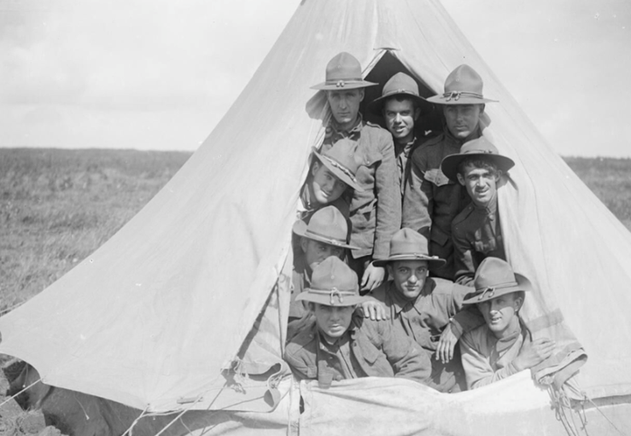 Troops of the railway regiments, the US Army Corps of Engineers, in a tent at the light railway depot at Boisleux-au-Mont, 2 September 1917. © IWM (Q 6081)