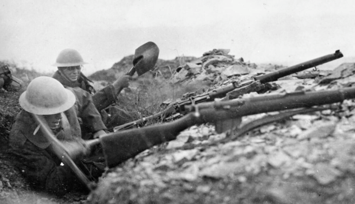 Two British infantrymen attempt to deepen a trench using pick and shovel in the rocky terrain around Doiran. (c) IWM HU 81087