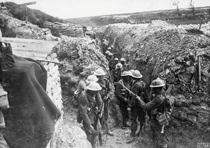 Battle of Albert. Soldiers of the 1st Battalion, Lancashire Fusiliers fixing bayonets prior to the attack on Beaumont Hamel, July 1916 (c) IWM Q 744