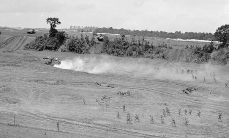 Infantry practising an attack behind a smoke screen and a tank. Photograph taken at Sautricourt, 12 July 1918. IWM Q9819