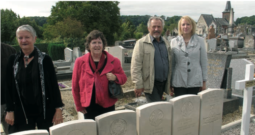The Collective Tomb of the Eleven British Soldiers, St. Médard Cemetery, Guise. (From left to right: Pat Elmer and Janet Arrowsmith (both Fred Innocent); Denis Chalandre (Vincent Chalandre); Sheila Dransfield (Matthew Wilson)).