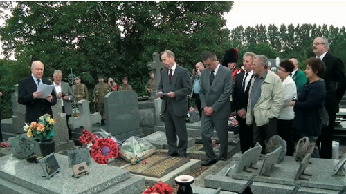 The Address at Chalandre’s graveside. (Left to right: Paul Crowther, translator; David Arrowsmith and Hedley Malloch respectively Secretary and Treasurer; and Chair of the Iron Memorial Fund; Mr. David Newlands; M. HuguesCochet, Mayor of Guise; Luc St. Clair of The Jocks (in Scottish Piper uniform); M. André Gruselle, Mayor of Iron; .M. Denis Chalandre, grandson of Vincent, MmeAnnickGoire, translator; Mme Denis Chalandre; and Paul-Anthony Byrne.)