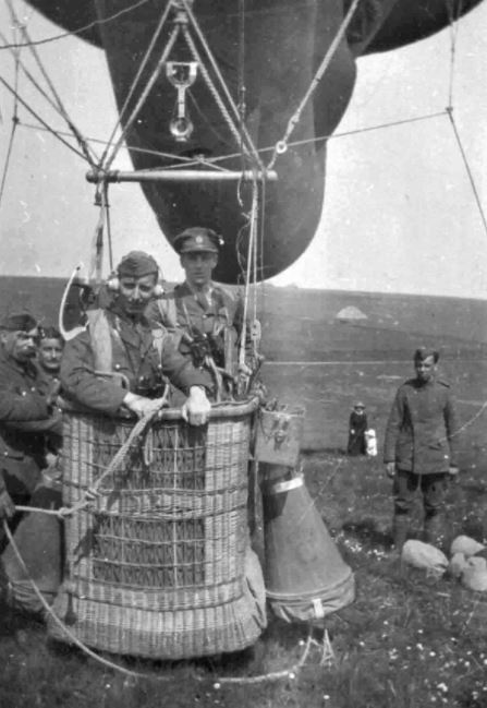 RFC Kite Balloon Observer Standing In An Anchored Balloon Basket (RAF Museum) The Cone Shaped Objects Hanging From The Side Are The Parachutes.
