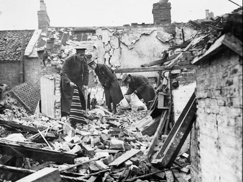 Soldiers Of The Territorial Forces Clear Up The Debris Following An Air Raid On King's Lynn. Behind Them, The Damaged Roofs Of Several Houses Can Be Seen. Image Courtesy Of The Imperial War Museum, Q 53589