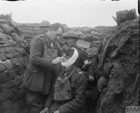 The Medical Officer Of The 12Th East Yorkshires, 92Nd Brigade, 31St Division, Bandaging The Face Wound Of A Man Of His Battalion In The Line In The Arleux Sector, Near Roclincourt, 9 January 1918. (IWM Q11545)