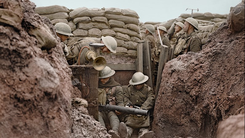 Men Of The Lancashire Fusiliers Sit In A Muddy Puddle On The Floor Of A Front Line Trench