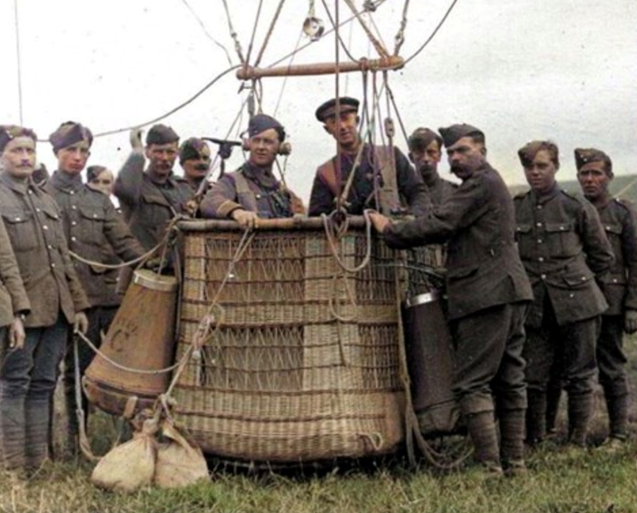RFC Kite Balloon Observer Standing In An Anchored Balloon Basket (RAF Museum) The Cone Shaped Objects Hanging From The Side Are The Parachutes. (1)