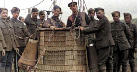 RFC Kite Balloon Observer Standing In An Anchored Balloon Basket (RAF Museum) The Cone Shaped Objects Hanging From The Side Are The Parachutes. (1)