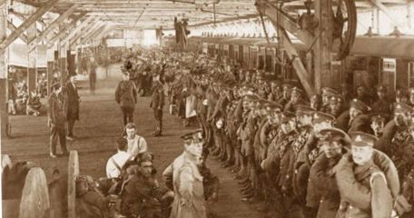 Troops in a dockside shed waiting to board their ship