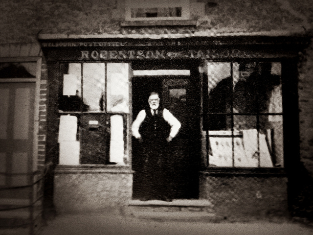 Thomas Robertson Standing At His Shop Door