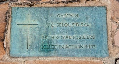 A Simple Bronze Plaque Marks His Grave.