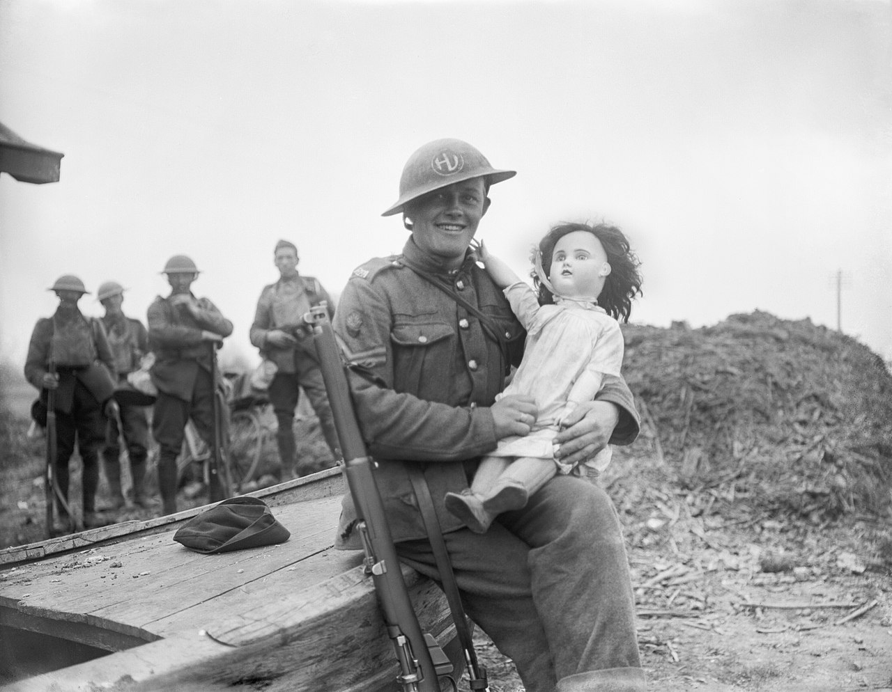 Publicity Photograph Of Tommy Atkins, A Soldier Of The 51St (Highland) Division, Seated With A Large Doll In His Arms