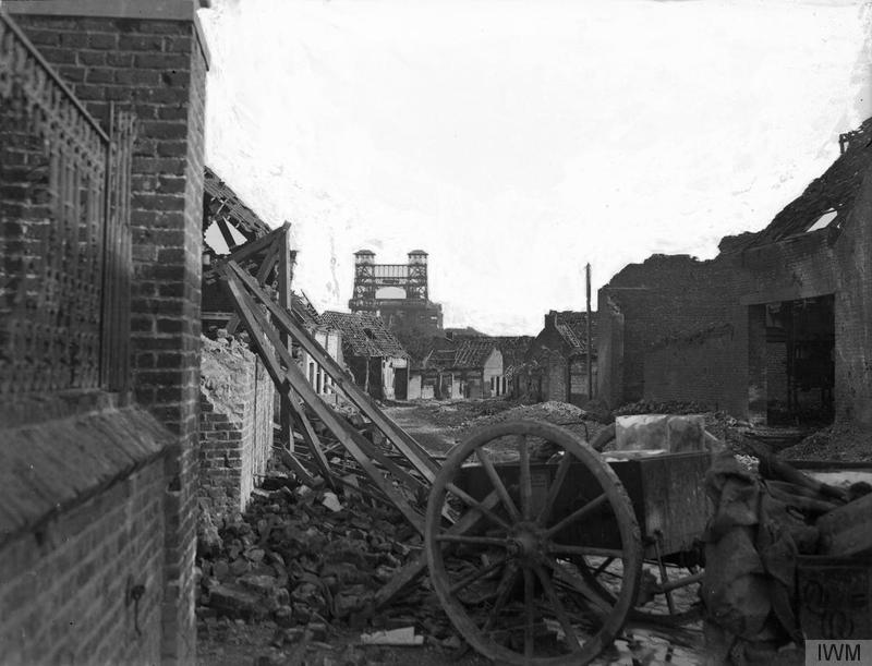 Wrecked British Transport Amongst The Debris In A Ruined Street, Loos, 30Th September, 1915. The Famous Tower Bridge Can Be Seen In The Distance. (C)IWM Q 28987
