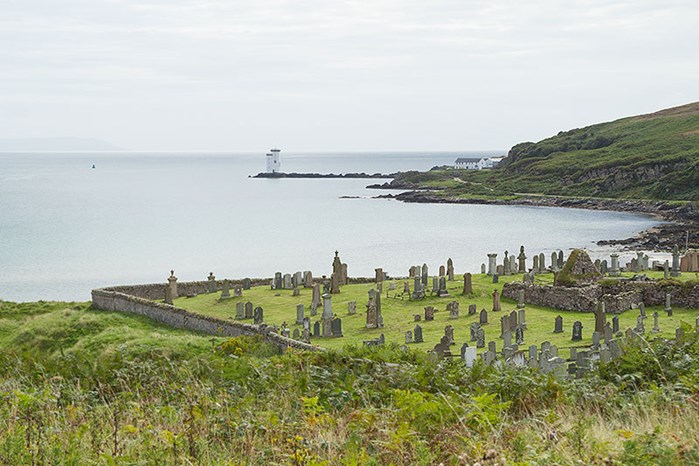 The Cemetery On Kilnaughton Bay, With Port Ellen Lighthouse. To The Left Is Kilnaughton Military Cemetery.
