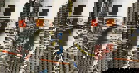 A French helmet from World War I and a modern helmet sit beneath a shock tube