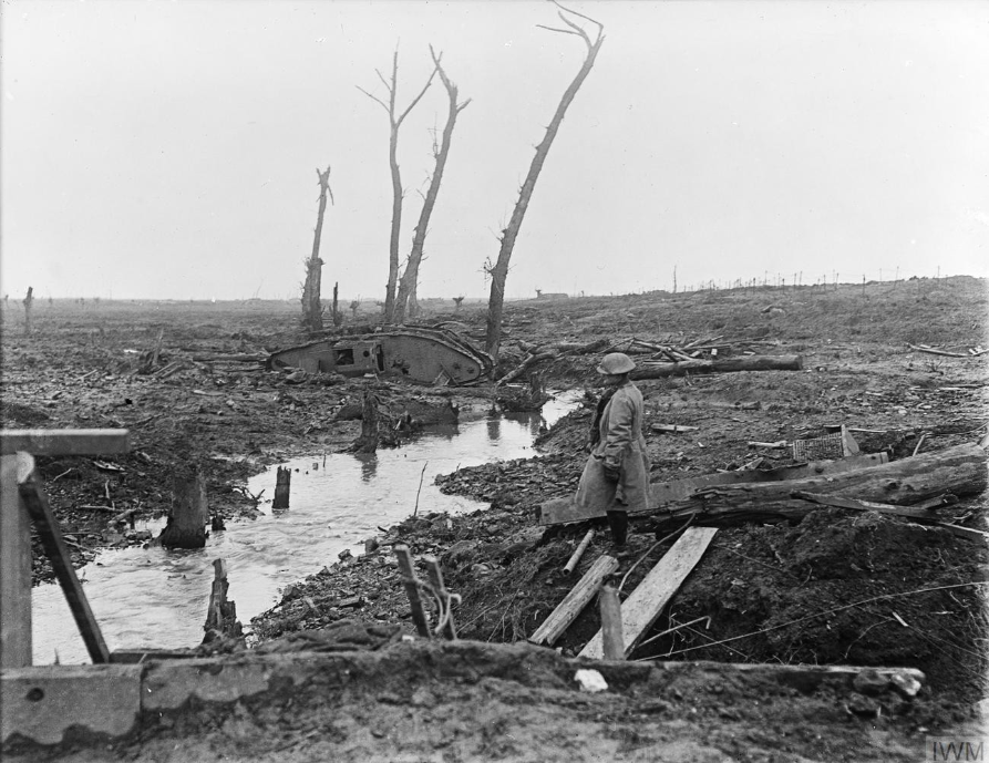 A Soldier Looks Across Devastated Country Near Ypres Showing A Derelict Mark IV Tank, Shell Splintered Trees And General Battle Detritus, 15 February 1918