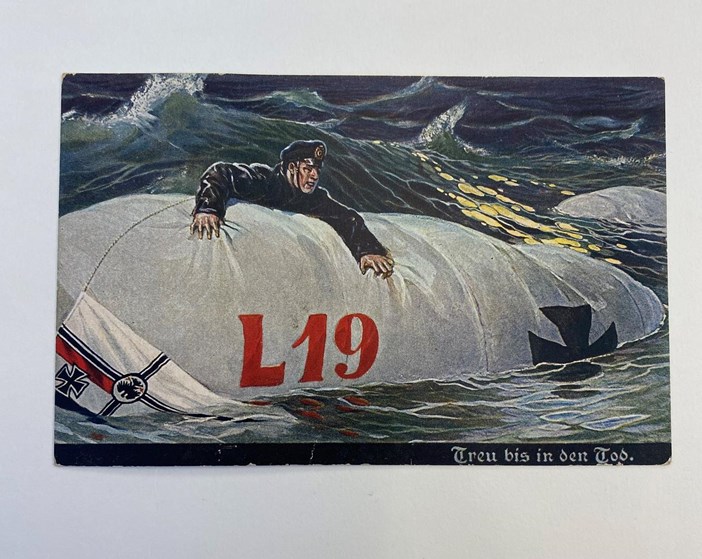 German Colour Printed Postcard Depicting A Member Of An Airship Crew Clinging To The Gas Bag Of Zeppelin L19 In A Rough Sea